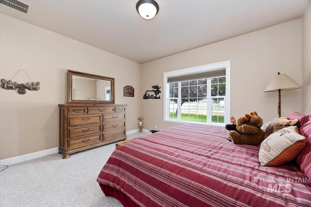 bedroom with carpet flooring, visible vents, and baseboards