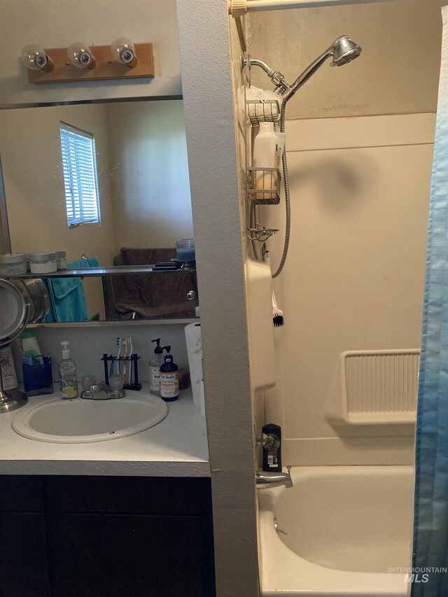 bathroom with shower / bathtub combination with curtain and vanity