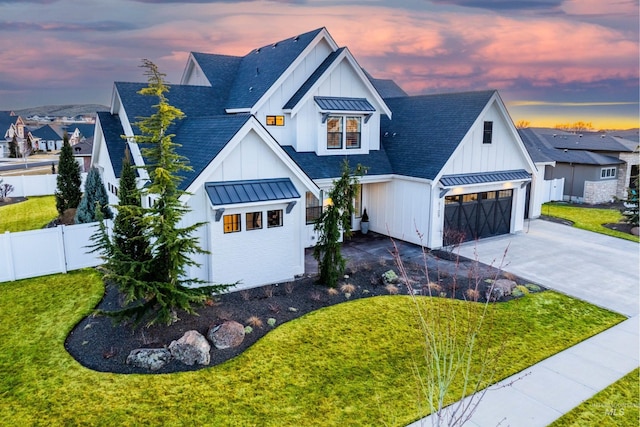 modern inspired farmhouse with a garage, a standing seam roof, board and batten siding, a shingled roof, and metal roof