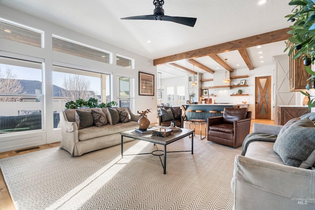 living room with a ceiling fan, visible vents, recessed lighting, light wood-style floors, and beamed ceiling