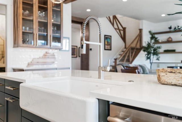 kitchen with light countertops, recessed lighting, and glass insert cabinets