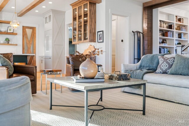 living room featuring beam ceiling, built in shelves, and recessed lighting