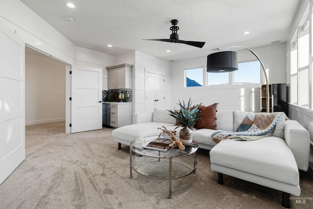 living area featuring recessed lighting, plenty of natural light, and light carpet