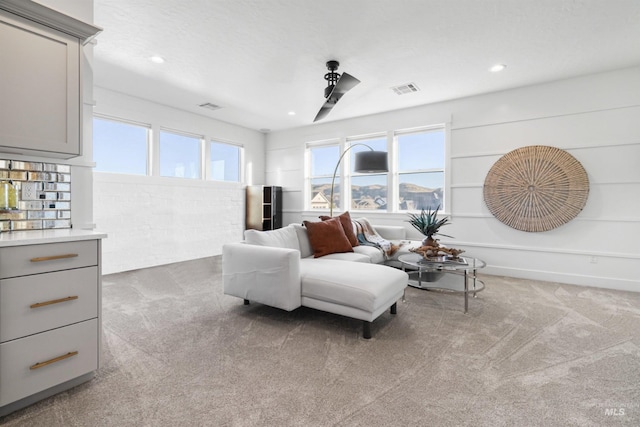 sitting room featuring recessed lighting, visible vents, and carpet