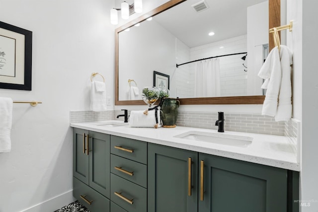 bathroom with double vanity, tasteful backsplash, visible vents, and a sink