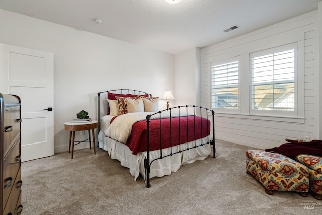 bedroom featuring carpet flooring and visible vents