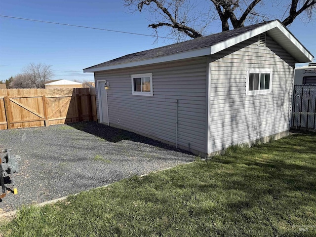view of outbuilding featuring an outbuilding and fence