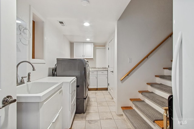 laundry area with cabinet space, washer / dryer, visible vents, light tile patterned flooring, and recessed lighting