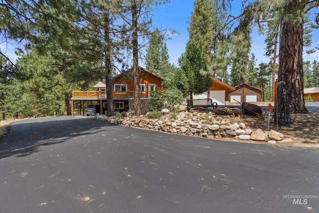 view of front of house with driveway and a wooden deck