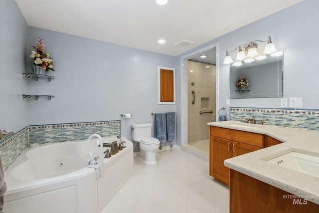 full bathroom featuring a stall shower, toilet, a jetted tub, vanity, and backsplash