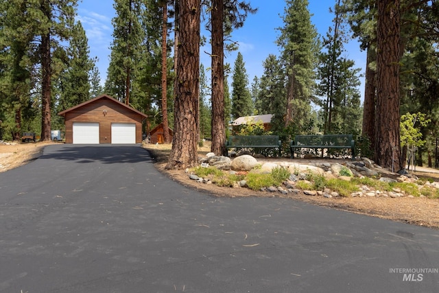 view of front of house featuring a detached garage and an outdoor structure