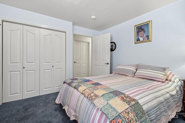 bedroom with dark carpet and a closet