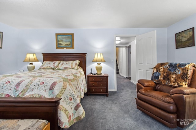 bedroom featuring carpet and baseboards