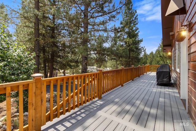 wooden terrace featuring a grill