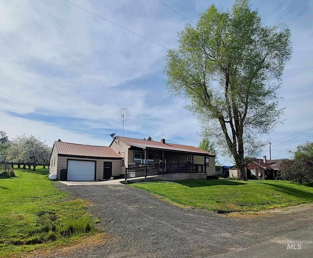 1120 N State St, Grangeville, ID 83530 - view of front of home with an attached garage, a front lawn, driveway, and metal roof