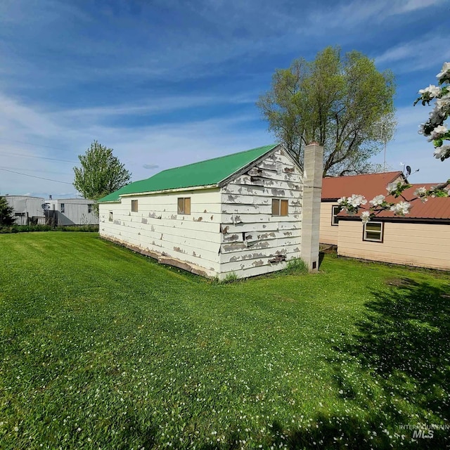 view of property exterior with a lawn