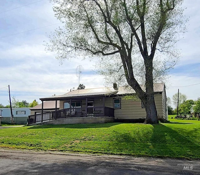 1120 N State St, Grangeville, ID 83530 - view of front facade featuring a front lawn, metal roof, and a porch