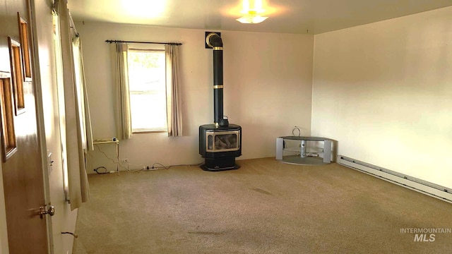 1120 N State St, Grangeville, ID 83530 - unfurnished living room with carpet flooring, a wood stove, and a baseboard heating unit