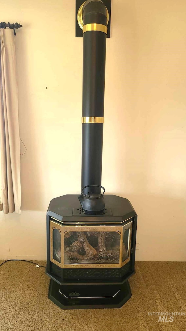 1120 N State St, Grangeville, ID 83530 - detailed view of a wood stove and carpet floors