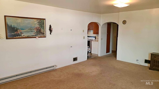 empty room with a baseboard radiator and light colored carpet