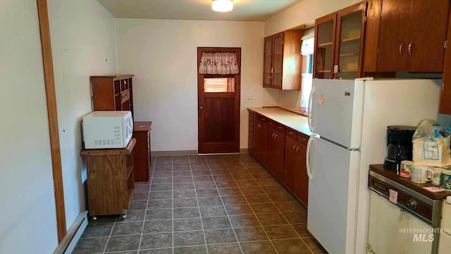 kitchen with dark tile patterned flooring and white appliances