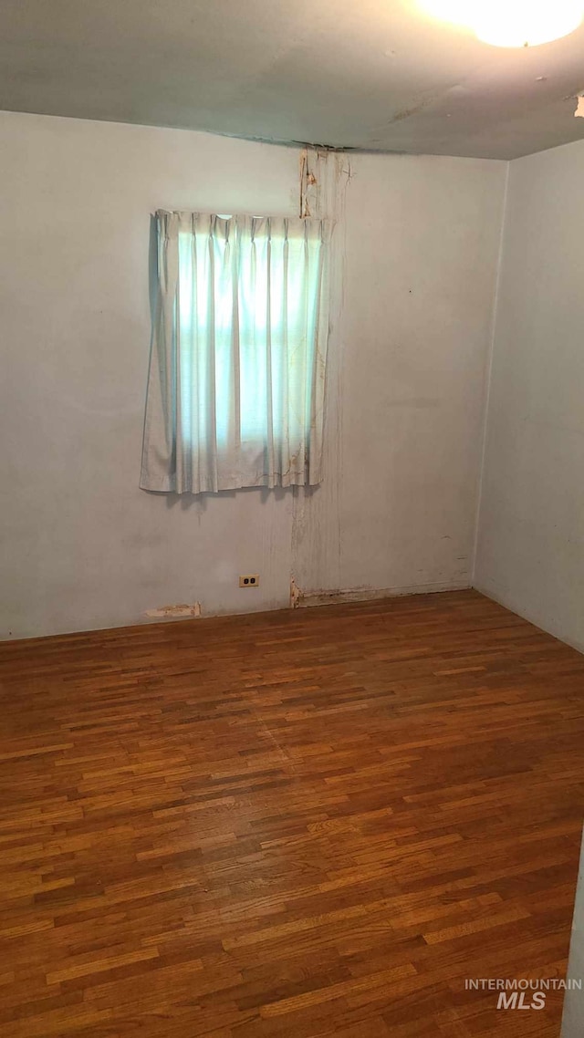 unfurnished room featuring hardwood / wood-style flooring