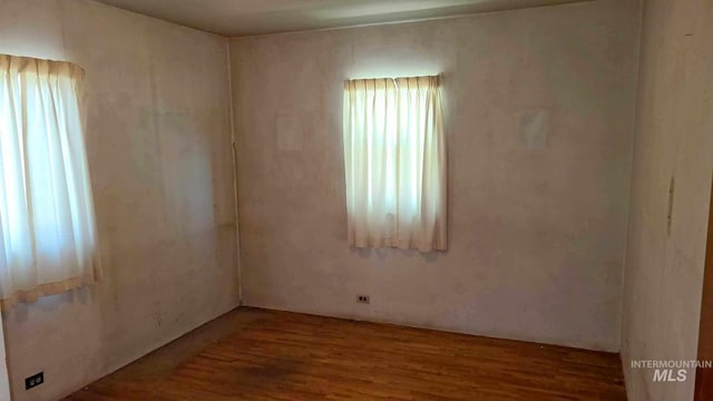 unfurnished room featuring hardwood / wood-style floors and a healthy amount of sunlight