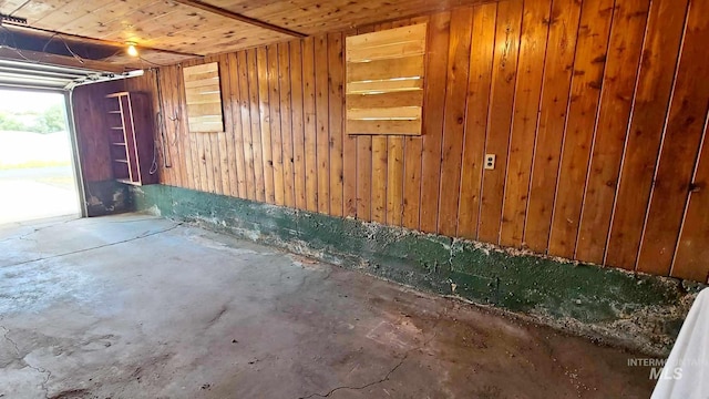 garage featuring wood walls and wood ceiling