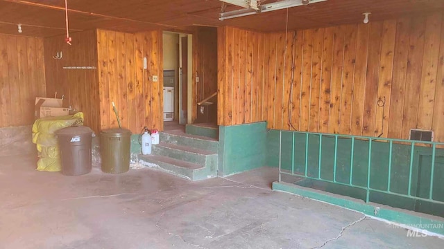 interior space with wood walls and concrete floors