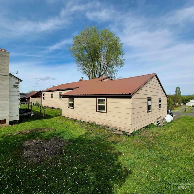 back of house with a lawn