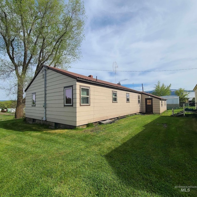 rear view of property featuring a yard