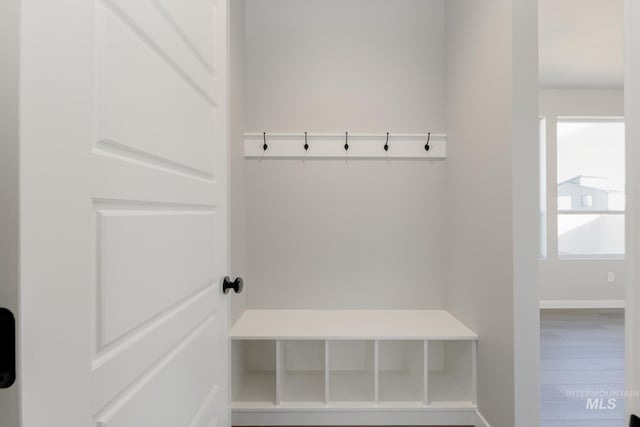 mudroom featuring wood finished floors and baseboards