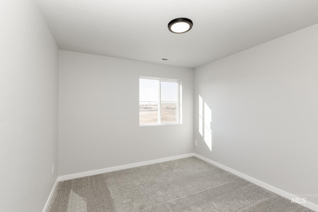 unfurnished room featuring baseboards, carpet flooring, and visible vents