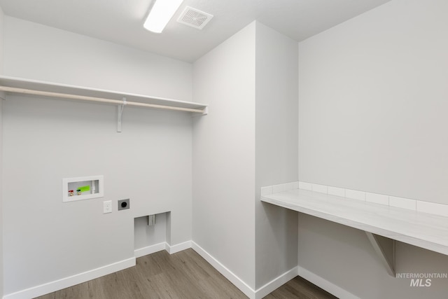 washroom with wood finished floors, laundry area, hookup for an electric dryer, visible vents, and hookup for a washing machine