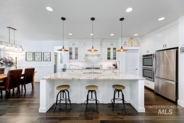 1833 N Monterossa, Eagle, ID 83616 - kitchen featuring stainless steel appliances, white cabinetry, tasteful backsplash, dark wood finished floors, and recessed lighting