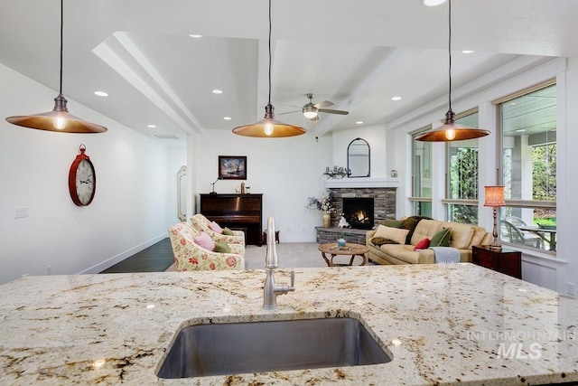 1833 N Monterossa, Eagle, ID 83616 - kitchen with a sink, a ceiling fan, light stone counters, a stone fireplace, and open floor plan