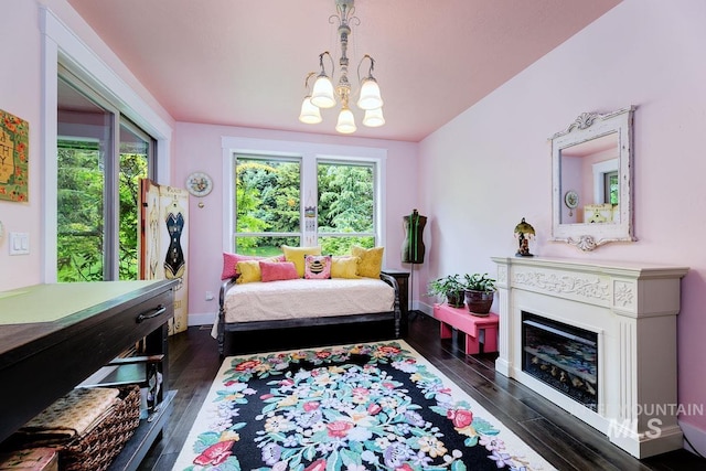 1833 N Monterossa, Eagle, ID 83616 - bedroom with dark wood-style flooring, a chandelier, baseboards, and a fireplace