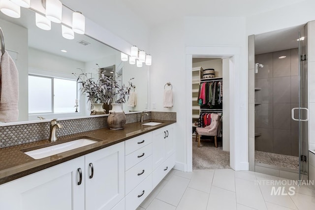 1833 N Monterossa, Eagle, ID 83616 - full bathroom with a stall shower, double vanity, tile patterned floors, a spacious closet, and backsplash