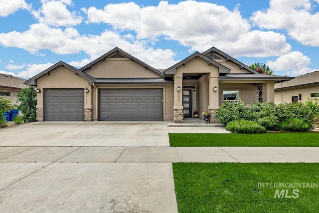 1833 N Monterossa, Eagle, ID 83616 - view of front of house with stucco siding, an attached garage, driveway, stone siding, and a front yard
