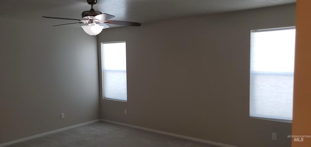 empty room with ceiling fan and carpet flooring