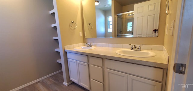 bathroom with hardwood / wood-style floors and double sink vanity