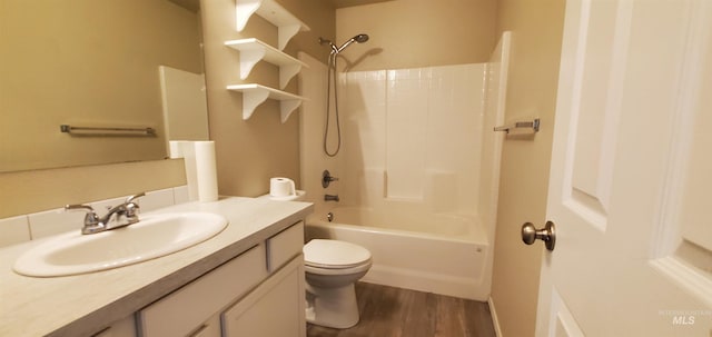 full bathroom with washtub / shower combination, wood-type flooring, toilet, and vanity