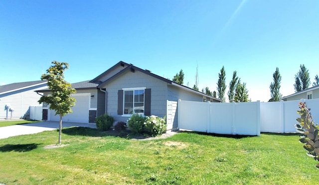 exterior space with a garage and a front lawn