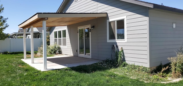 back of property with a patio and a yard