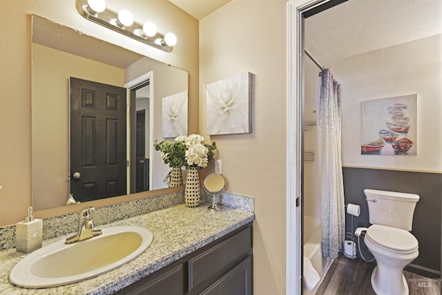 2908 E Iowa Ave, Nampa, ID 83686 - full bathroom featuring toilet, vanity, wood finished floors, and shower / bath combo with shower curtain
