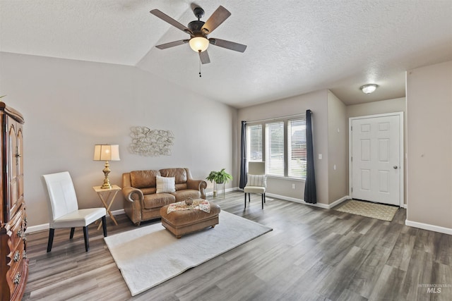2908 E Iowa Ave, Nampa, ID 83686 - living room with wood finished floors, baseboards, ceiling fan, vaulted ceiling, and a textured ceiling