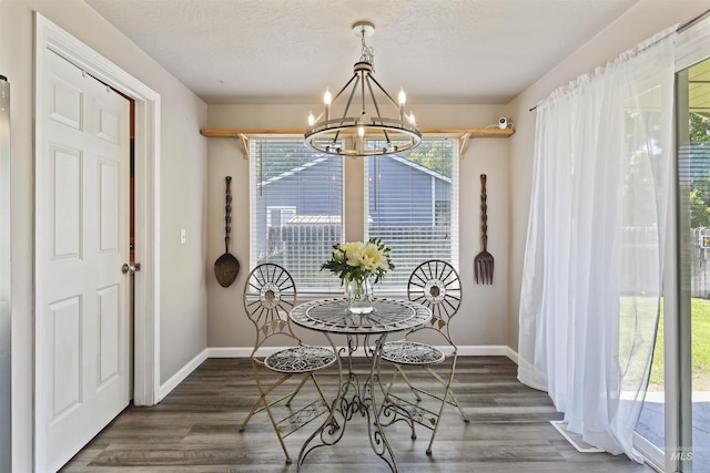 2908 E Iowa Ave, Nampa, ID 83686 - dining space featuring a chandelier, baseboards, and wood finished floors