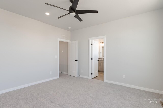 2804 N Eagle Meadow Ave, Kuna, ID 83634 - unfurnished bedroom featuring visible vents, connected bathroom, baseboards, light carpet, and recessed lighting