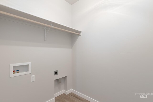 2804 N Eagle Meadow Ave, Kuna, ID 83634 - laundry room with light wood-style flooring, baseboards, hookup for an electric dryer, hookup for a washing machine, and laundry area