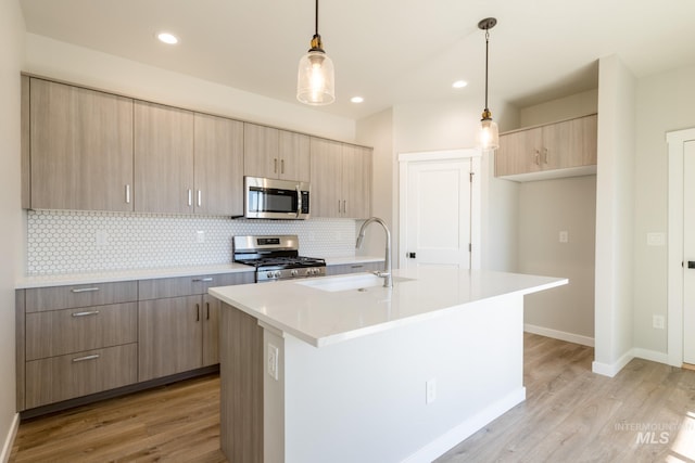 2804 N Eagle Meadow Ave, Kuna, ID 83634 - kitchen with a sink, stainless steel appliances, light countertops, light wood-style floors, and backsplash